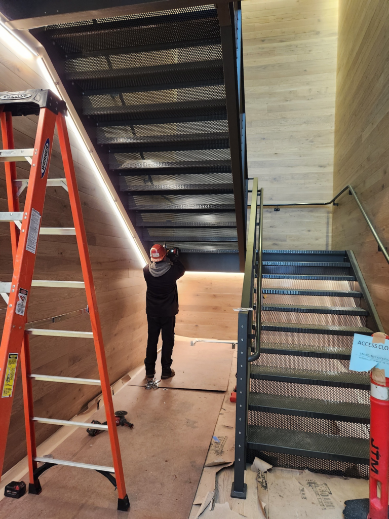 This is a photo of a Pacific Facilities employee working on stairs that we just installed.